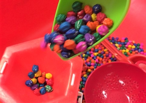 Dyed chickpeas in a sensory bin