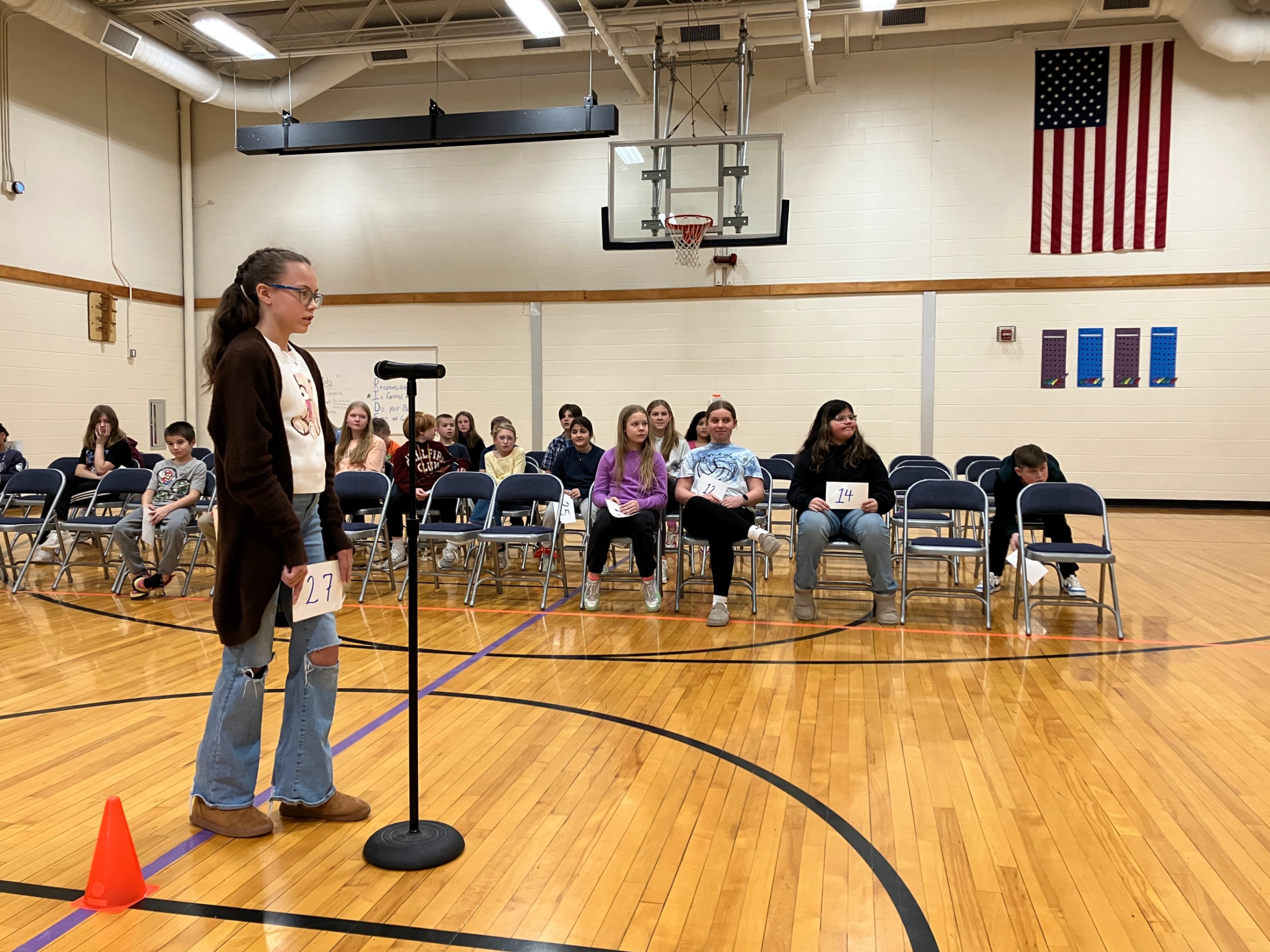 Quinn Miner approaches the mic to spell her assigned word during the recent spelling bee at Hickory Grove.