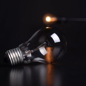 Incandescent lightbulb laying on a flat surface