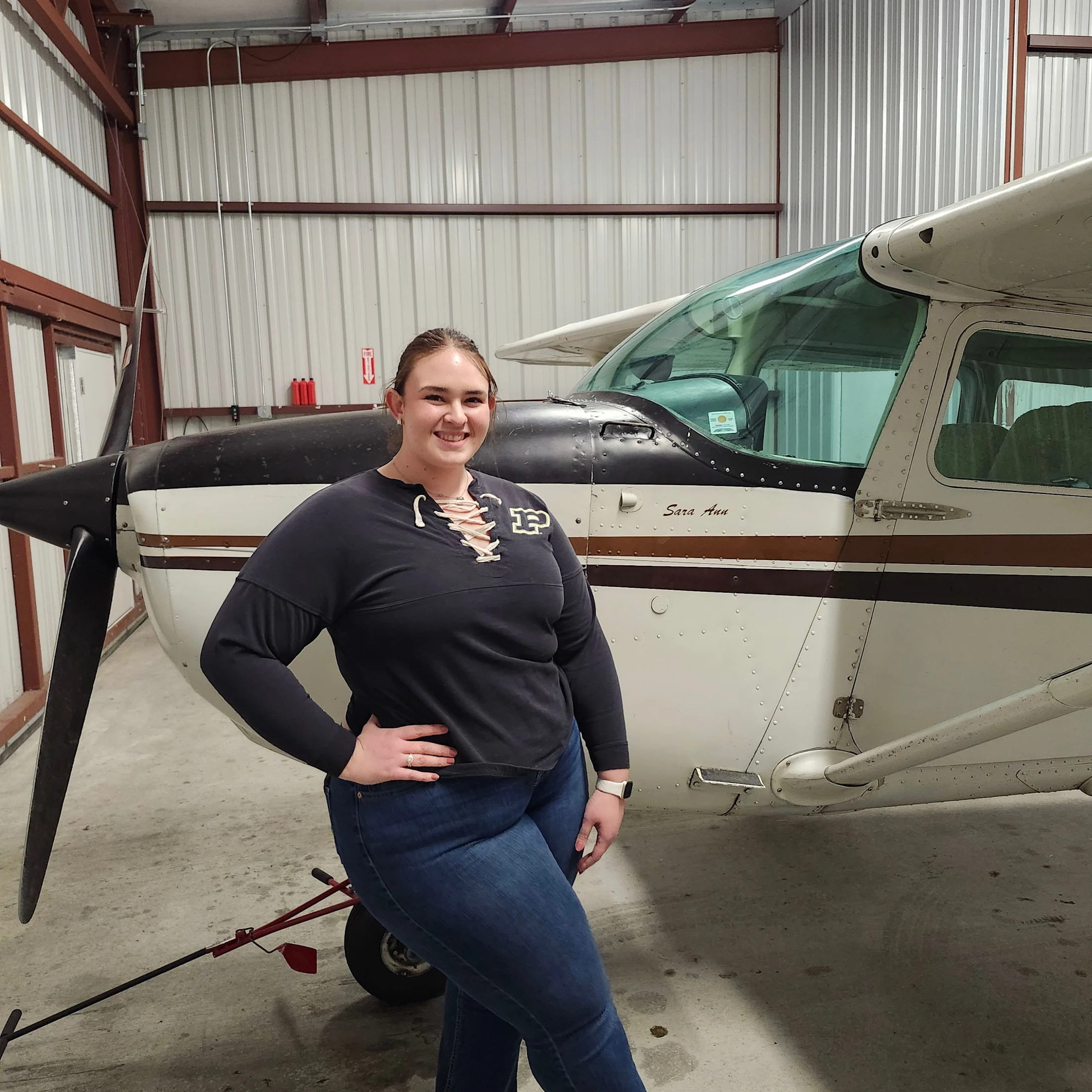 young lady next to airplane