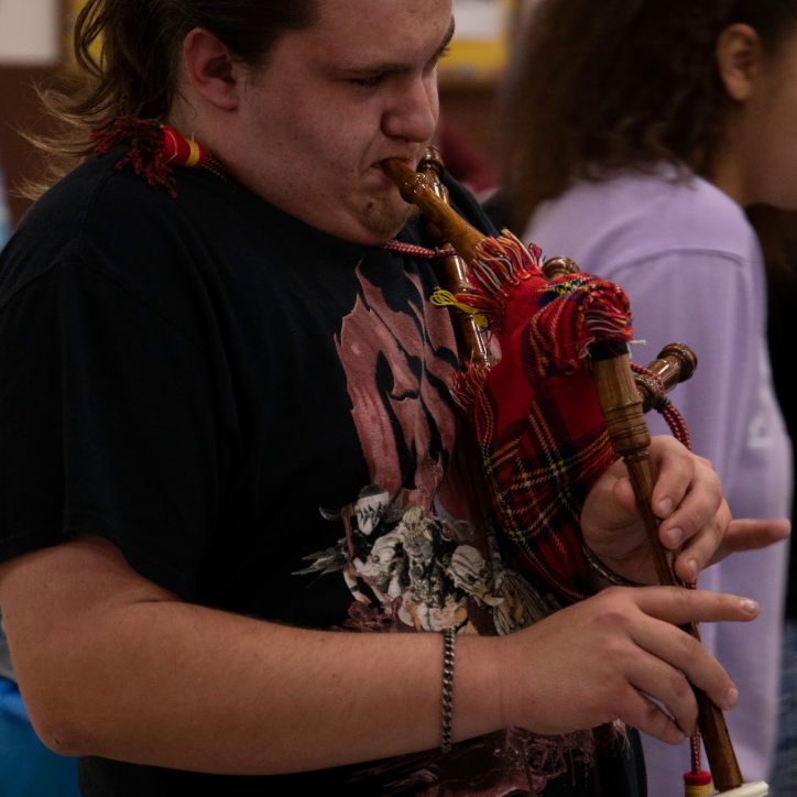 student playing bag pipe