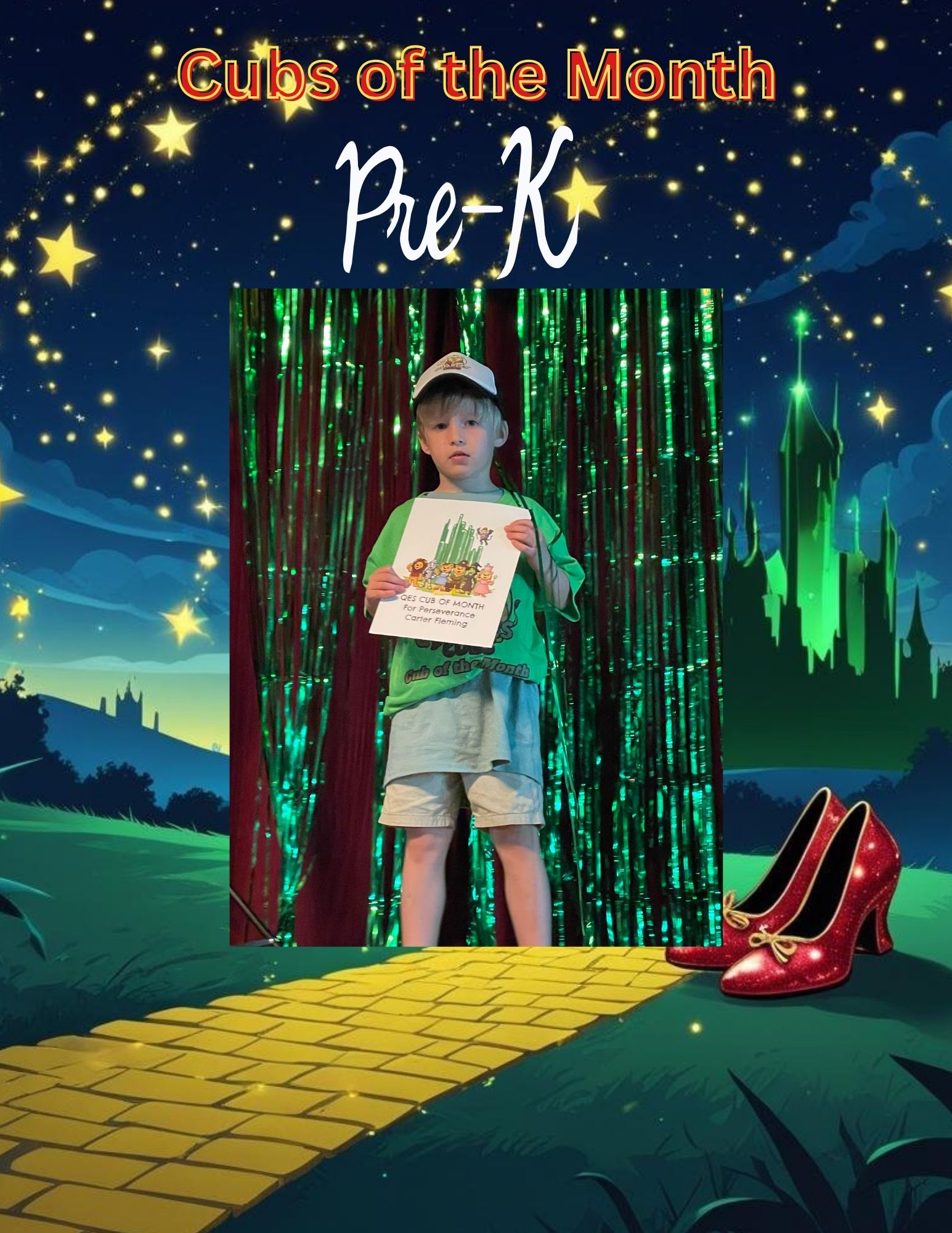 A young child stands smiling in front of a green, shimmering backdrop designed like a “Wizard of Oz” scene, with a yellow brick road, a distant castle, and red shoes on the right. The child holds a certificate that reads “Cub of the Month for Perseverance – Carter Fleming.” Text at the top of the graphic says “Cubs of the Month” and “Pre-K” in bright colors with star decorations.