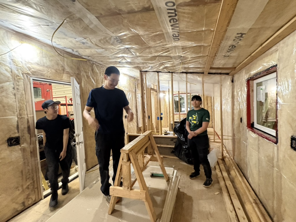 students constructing a house