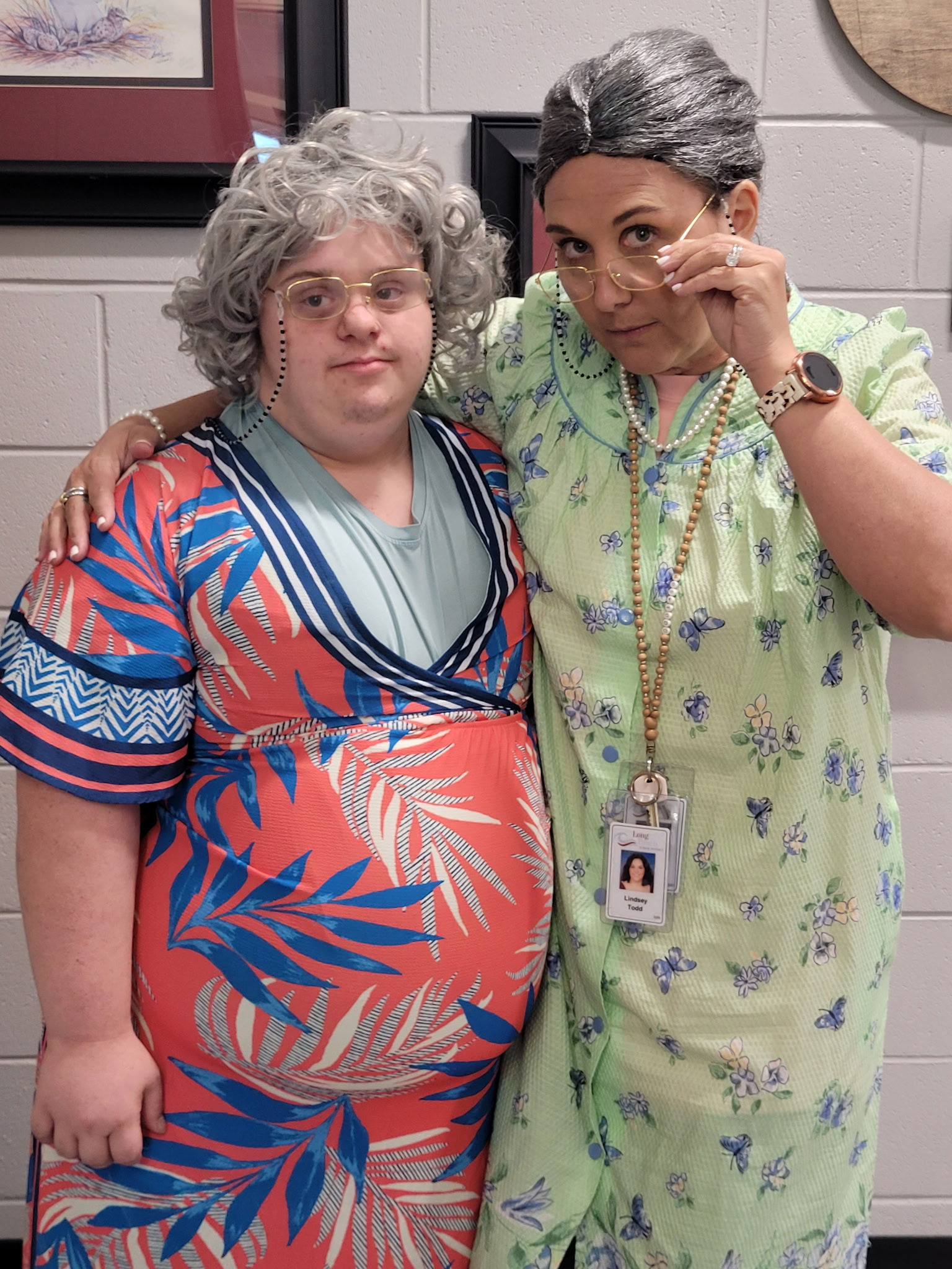 Assistant principal and student dressed up for football spirit them as old people