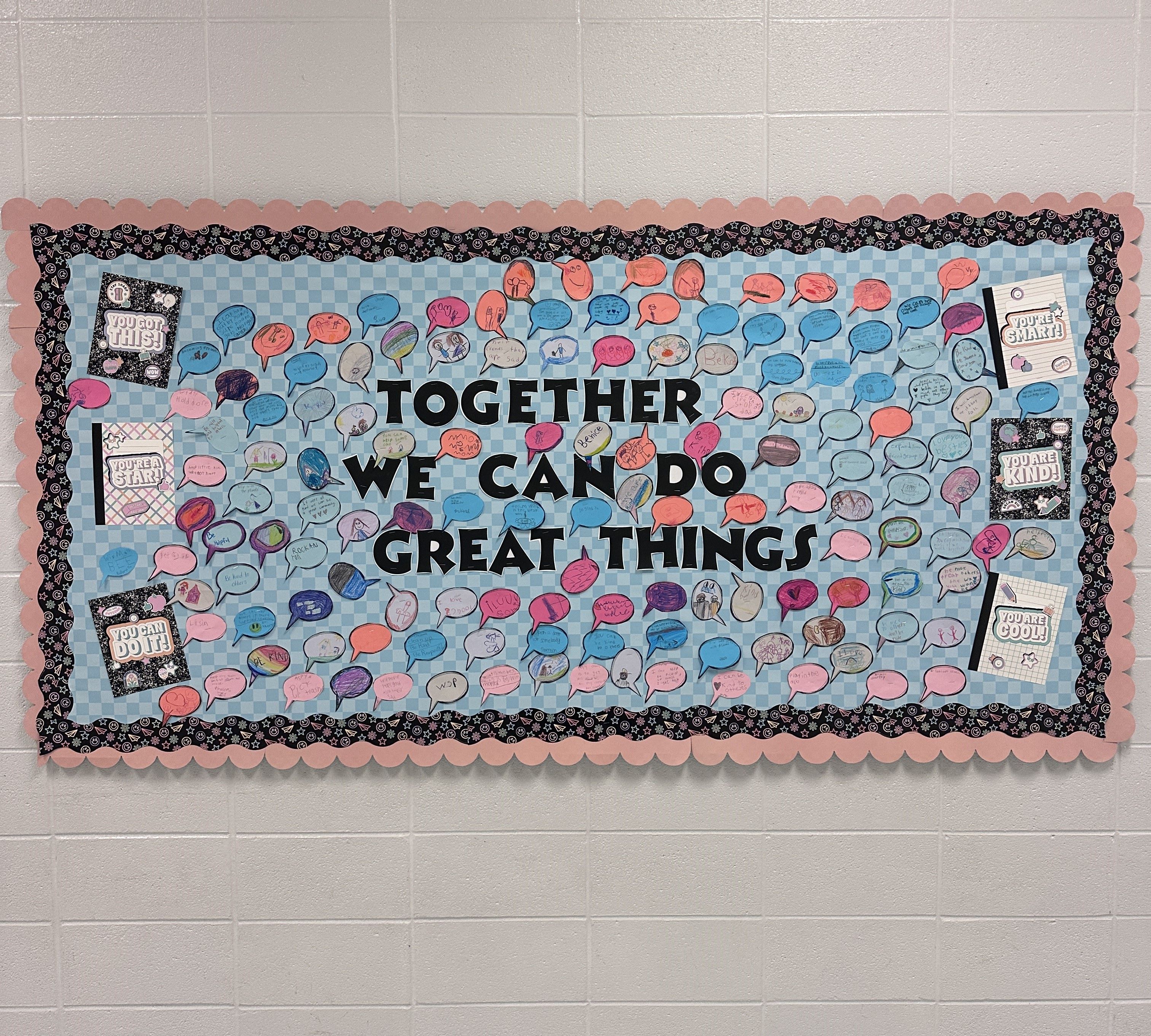Bulletin board with student work and the words Together We Can Do Great Things