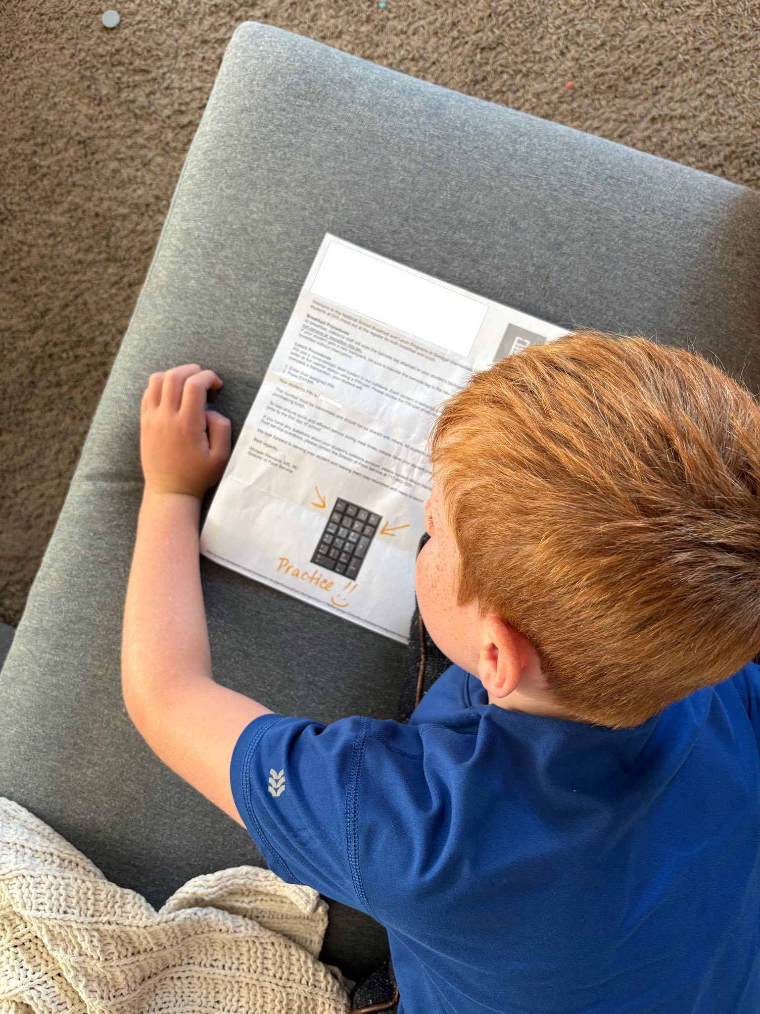 student looking at paper and computer