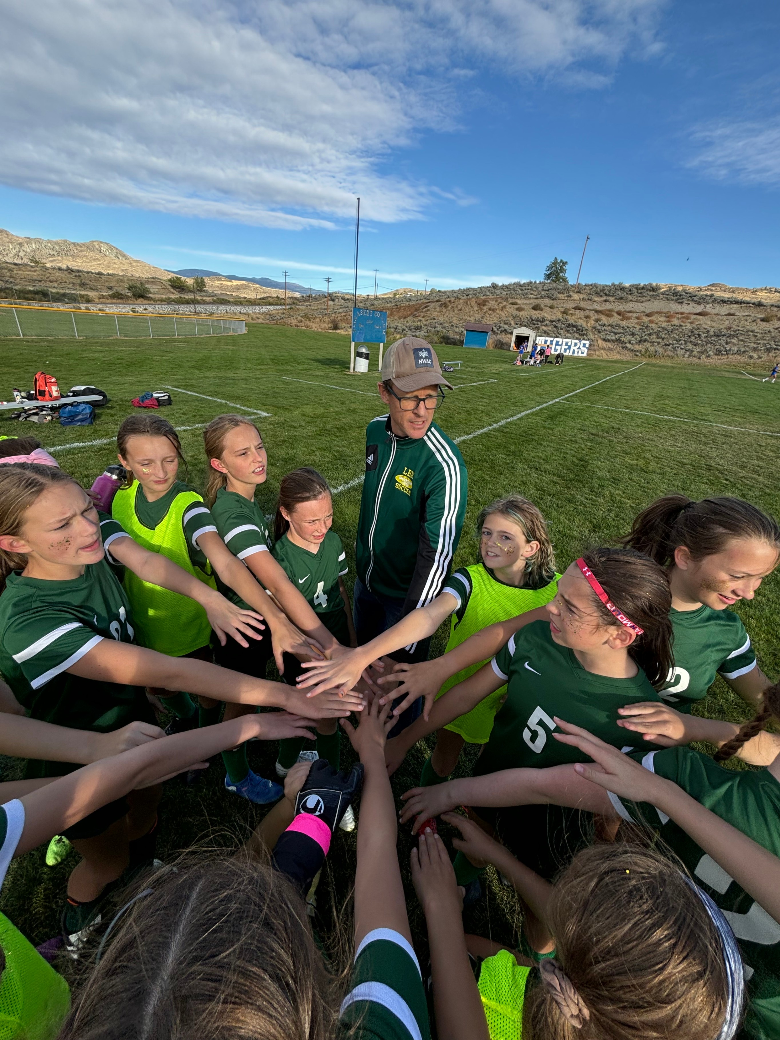 Coach Grayum leads his team in a rousing cheer