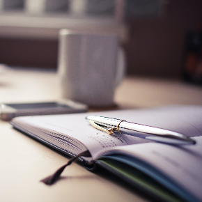 pen and paper and coffee cup
