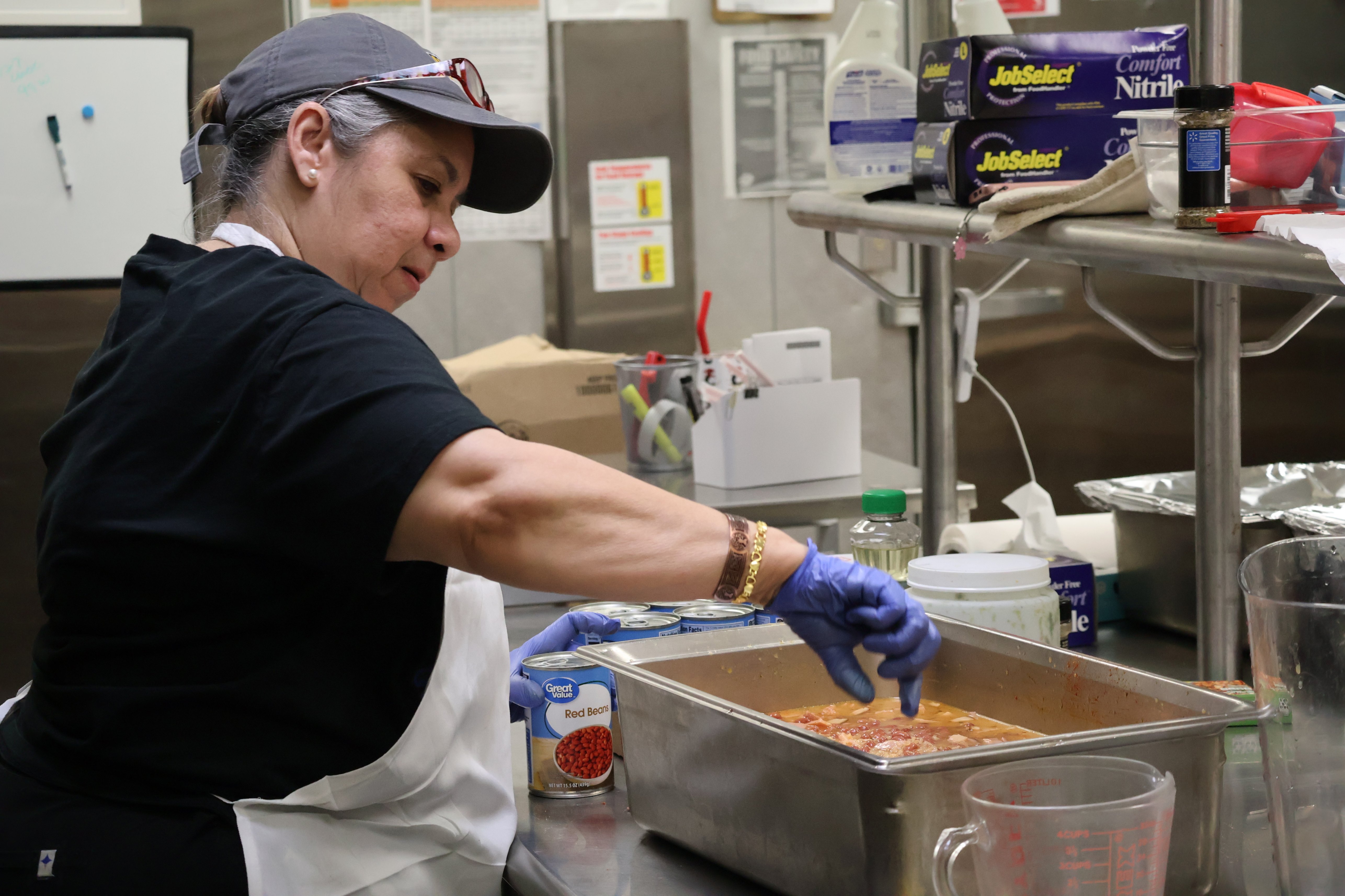 Ingrid adds ingredients to container of rice