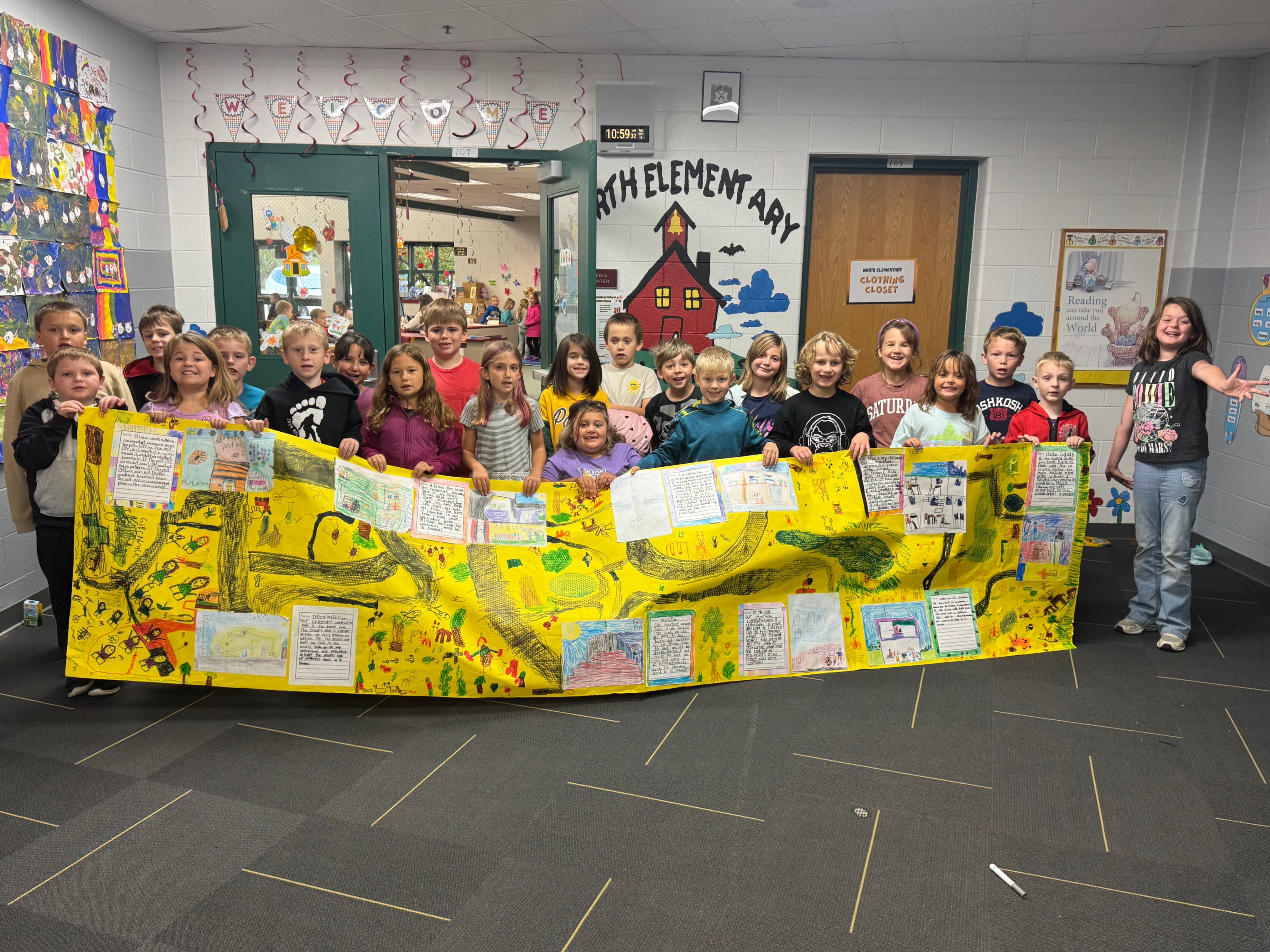 students stand behind banner illustrating community