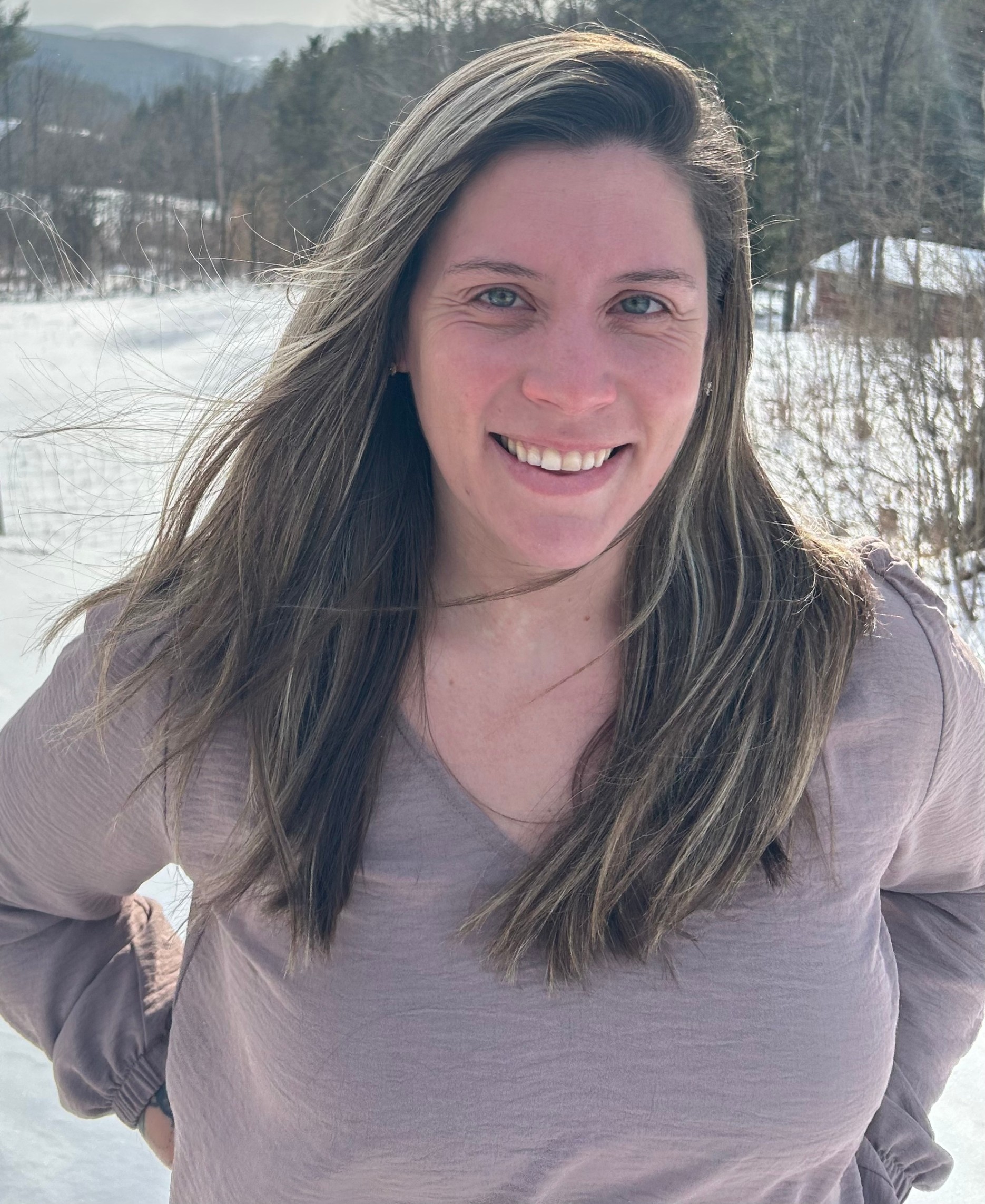 Woman standing outside in a snowy field 