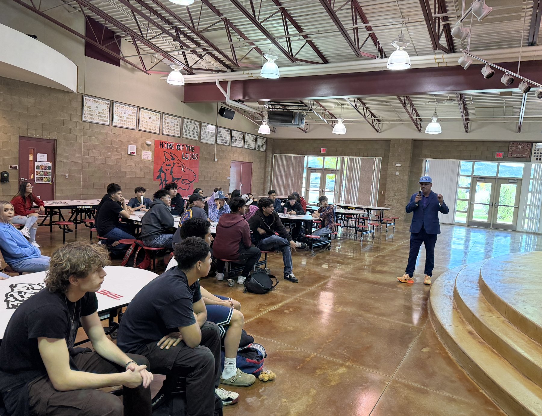 Javier Vigil of the Northern NM ROC Foundation speaks to Escalante juniors and seniors in the cafeteria on October 7
