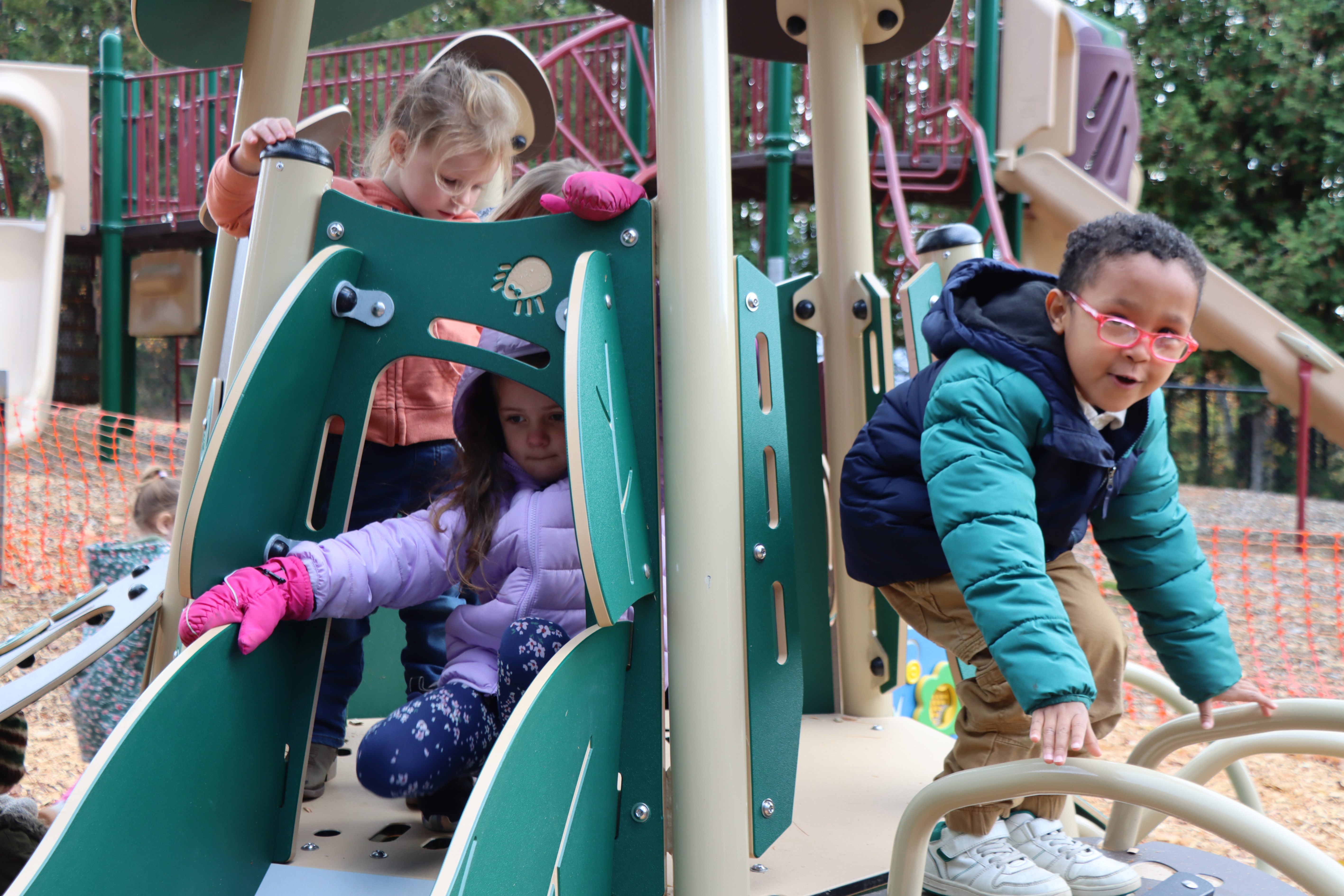 students playing on outdoor equipment
