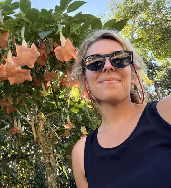smiling lady in front of giant lilly pads