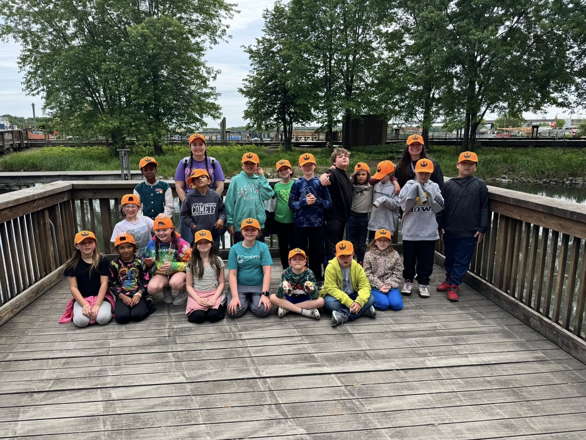 students pose on a dock