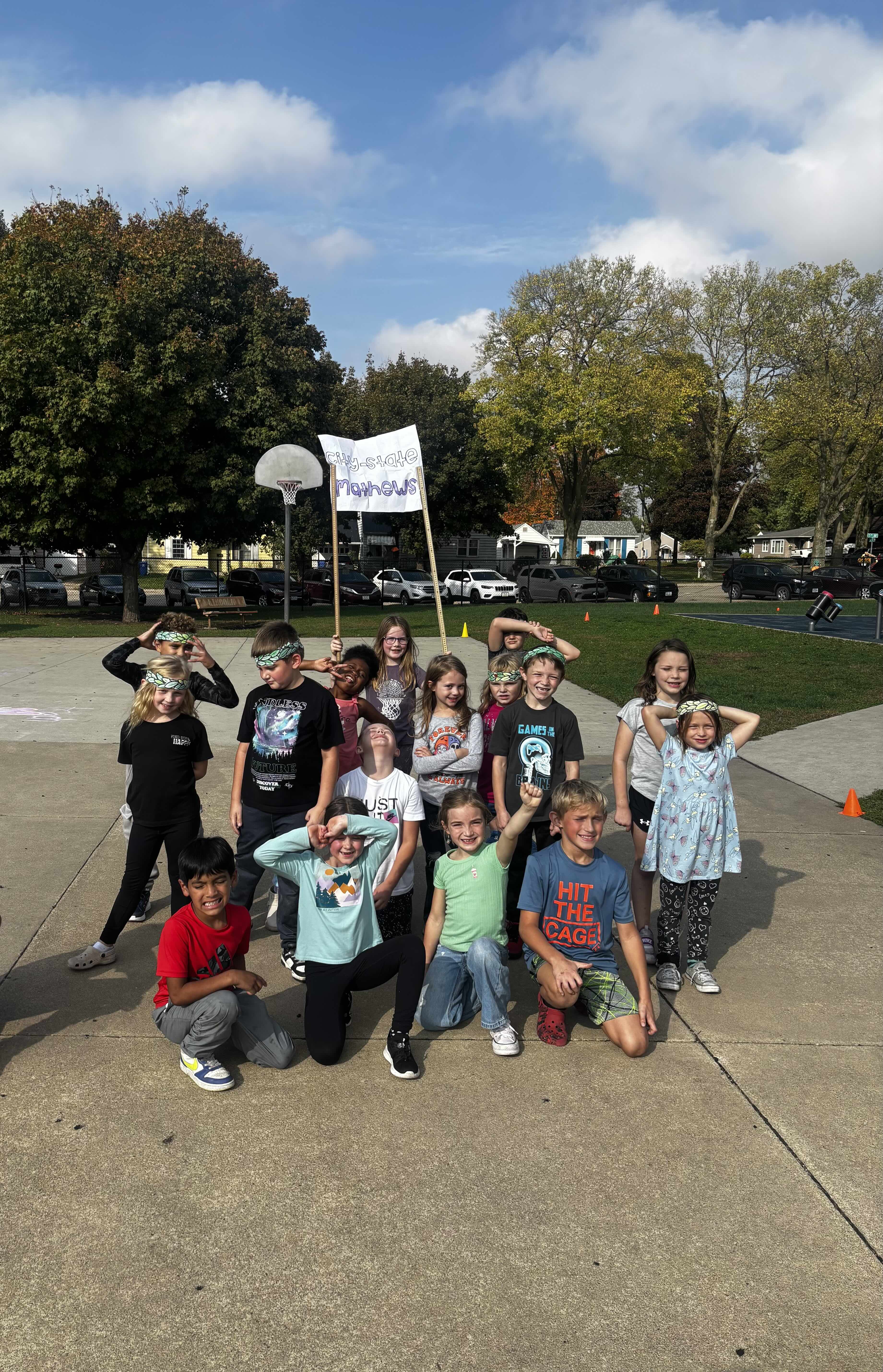 Ms. Mathews' students holding their "city-state Mathews" flag on the Lincoln Elementary Playground