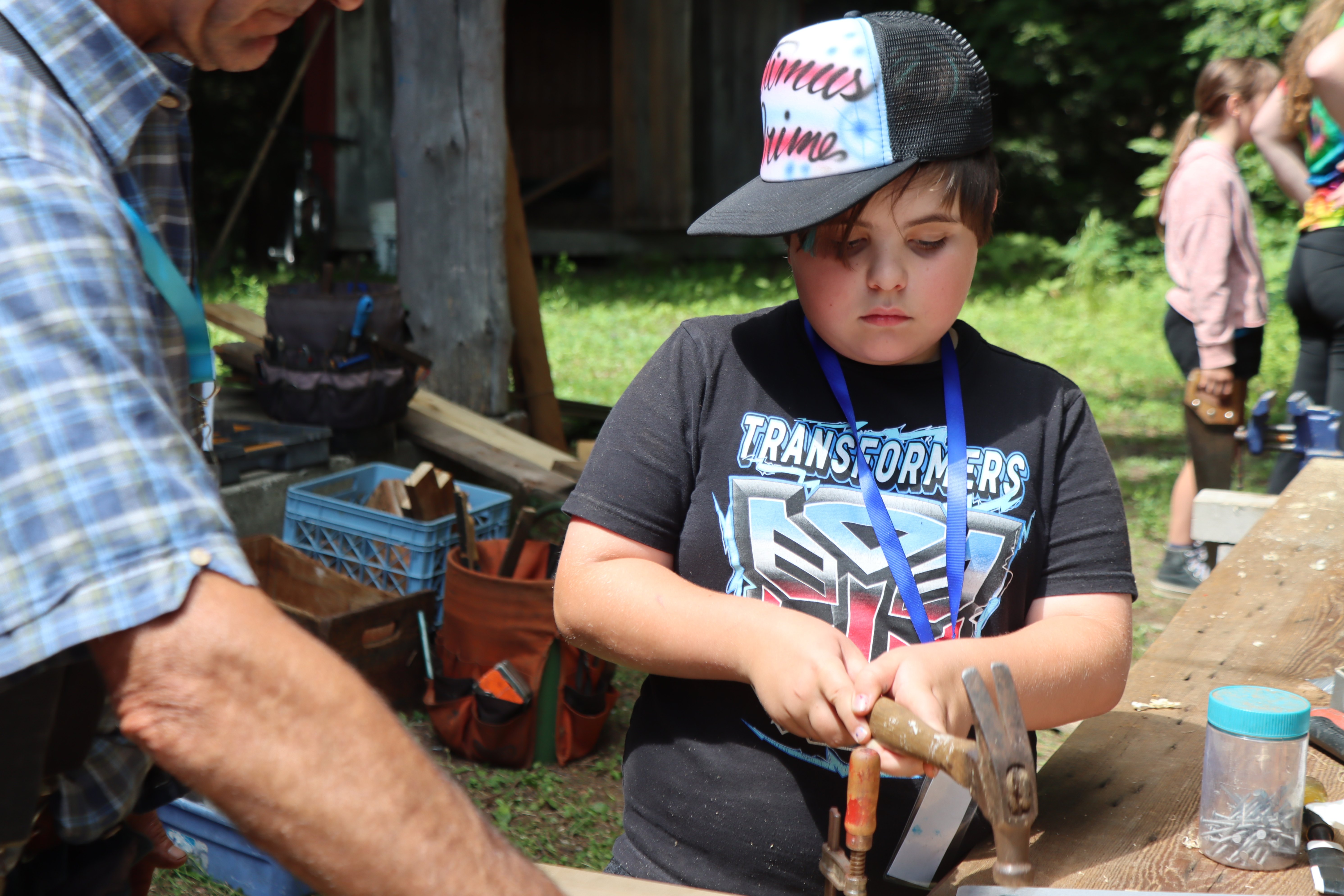 camper hammering during woodworking session