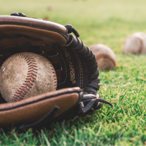 Baseball in a glove on the grass