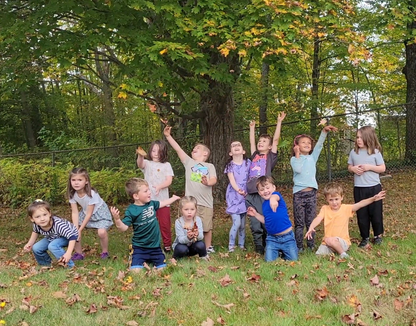 Mrs. Towne's Kindergarten Class plays in leaves