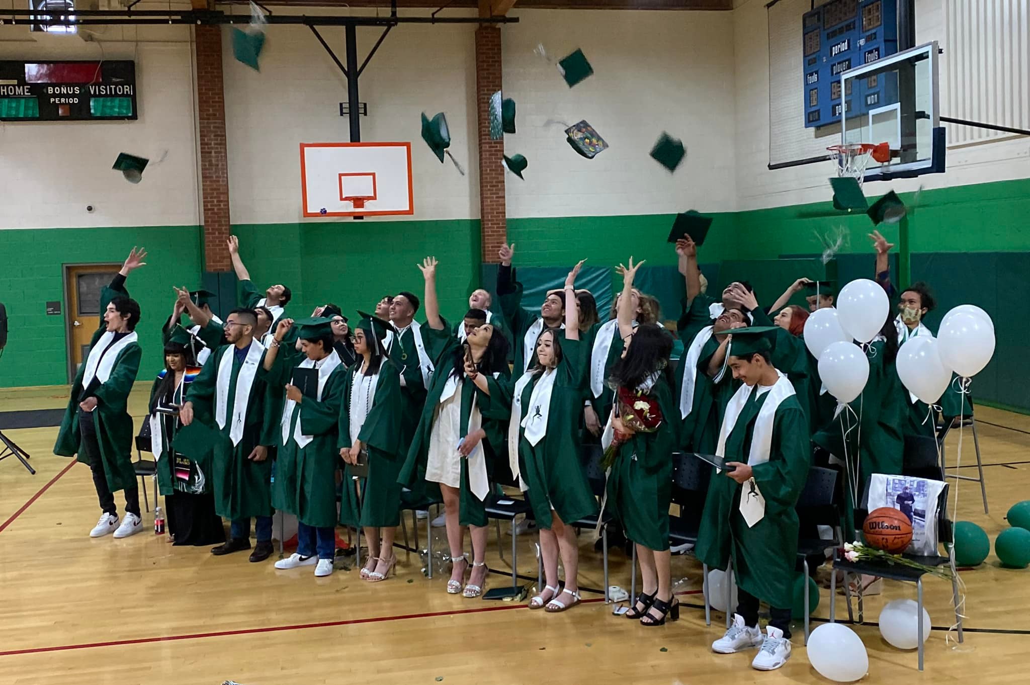 Students throwing their mortarboards up on the air upon graduation