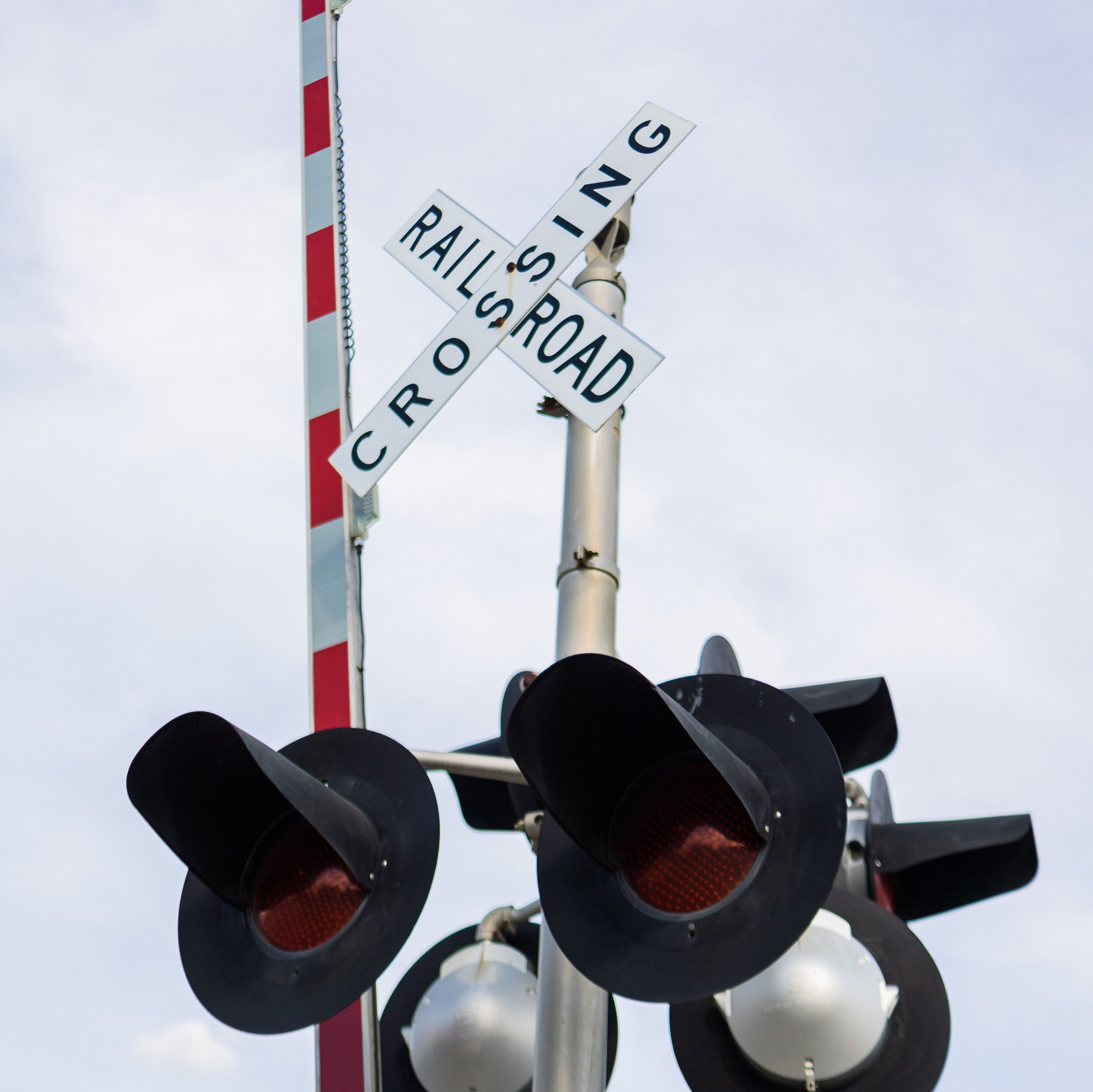 Railroad crossing with a raised arm and lights