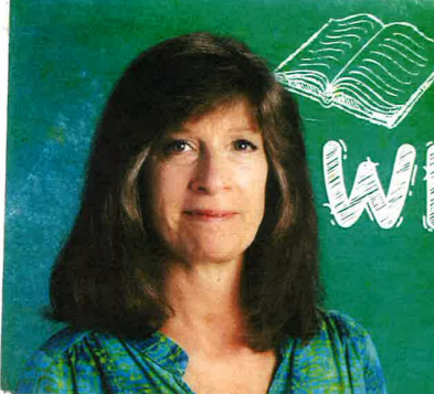 headshot of a woman with cropped gray hair and a kind smile. 
