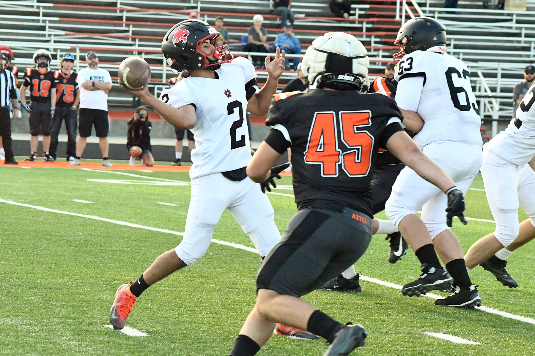 Ignacio’s William Mendoza-Lechuga (2) looks to throw long during the Bobcats’ scrimmage Friday night, August 14, in and against Aztec, N.M. The pass was completed for a 29-yard touchdown to Evan Maez.