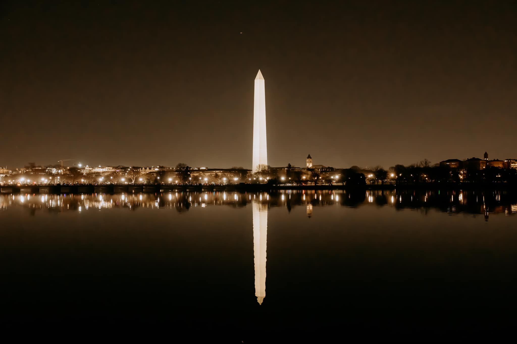 Washington DC at night with the Washington Monument in the center lit up