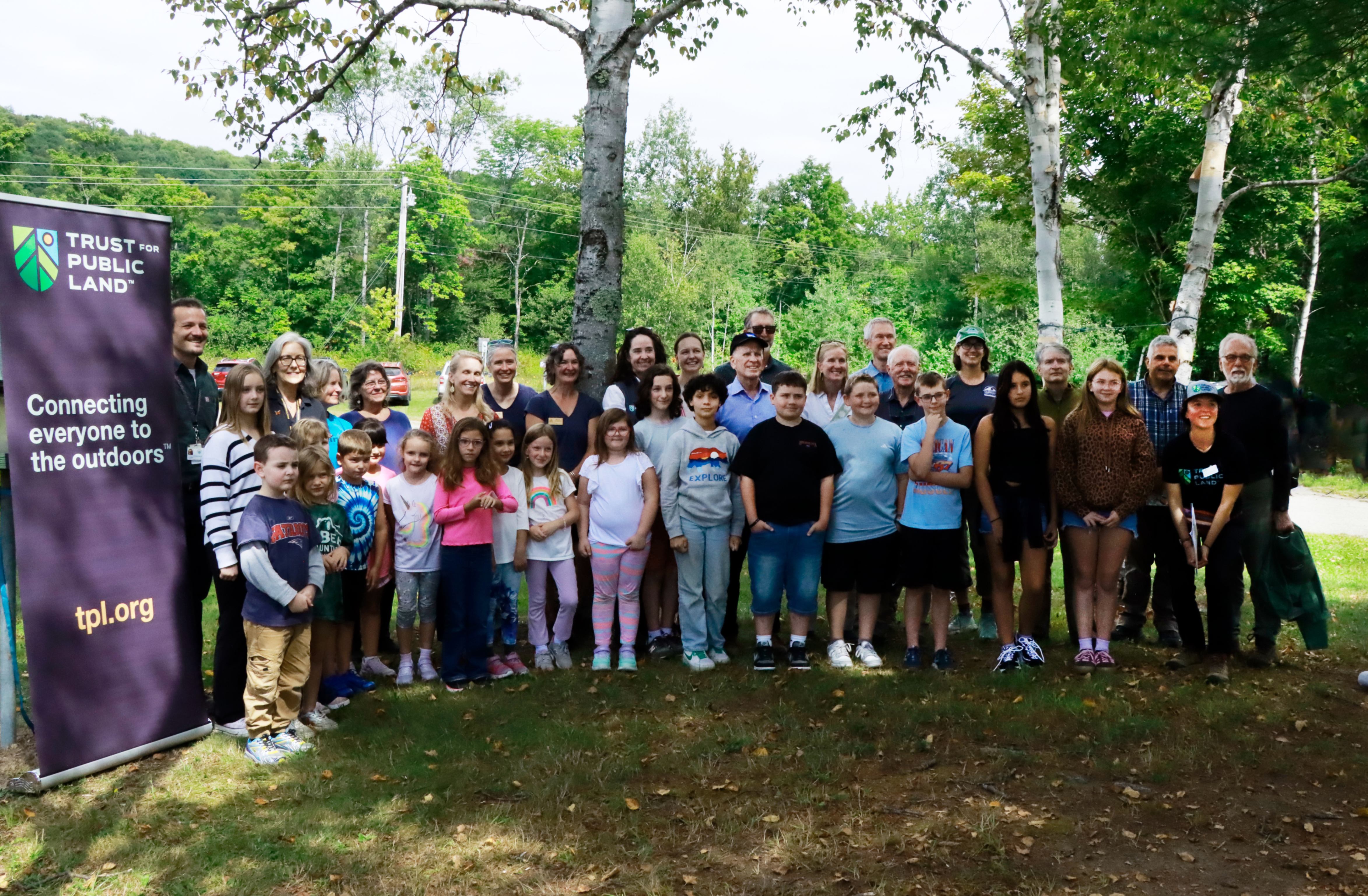 group gathers in front of Wolcott Elementary before the hike