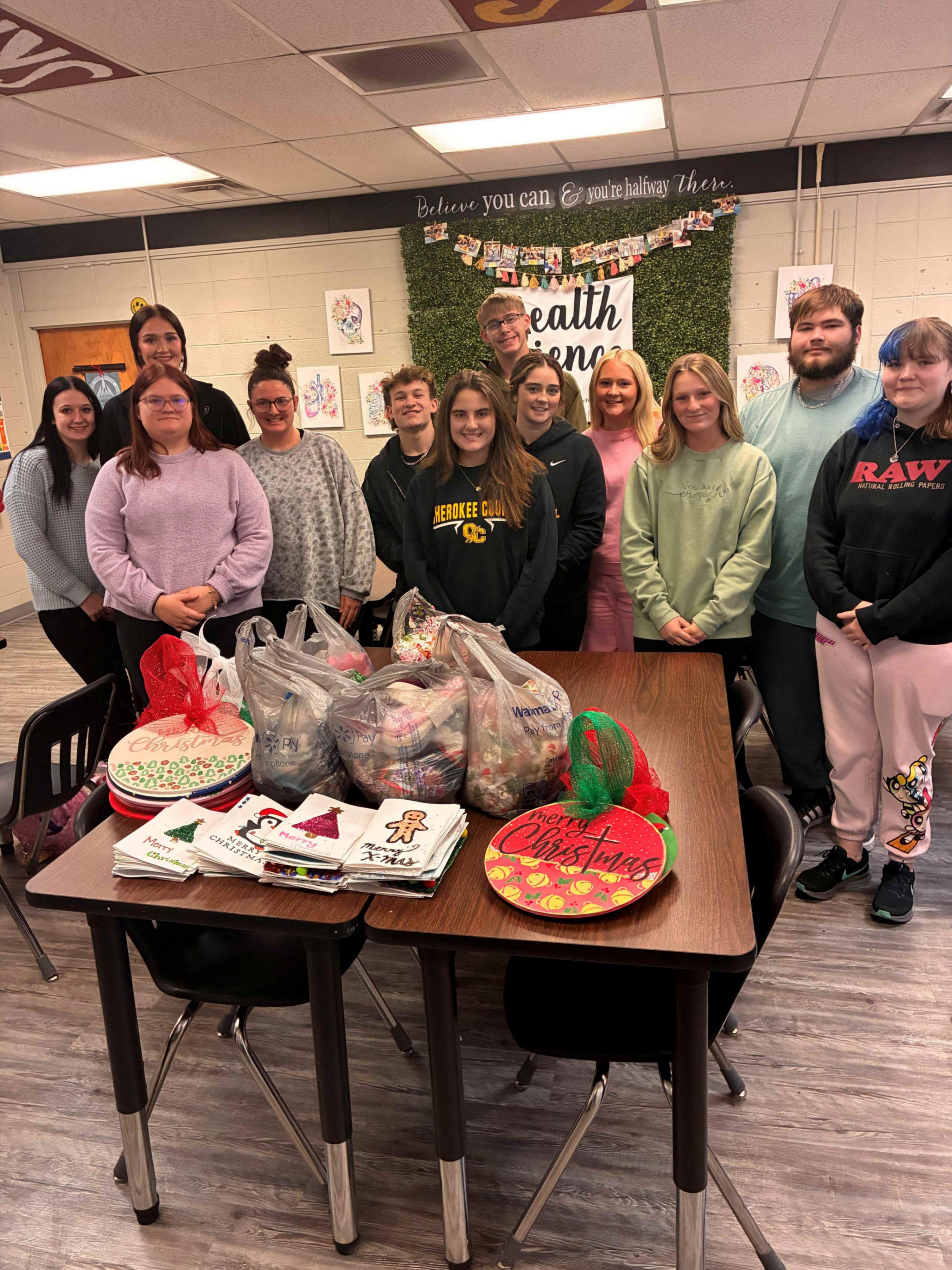 HOSA students standing with their Christmas gifts for nursing home