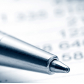 Close up of the tip of a pen with some numbers behind it