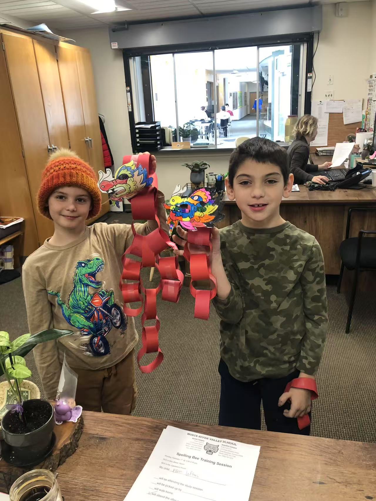 two male students showing off their artwork