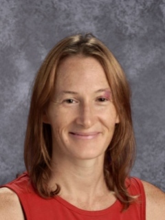 headshot of a woman in a red top. 