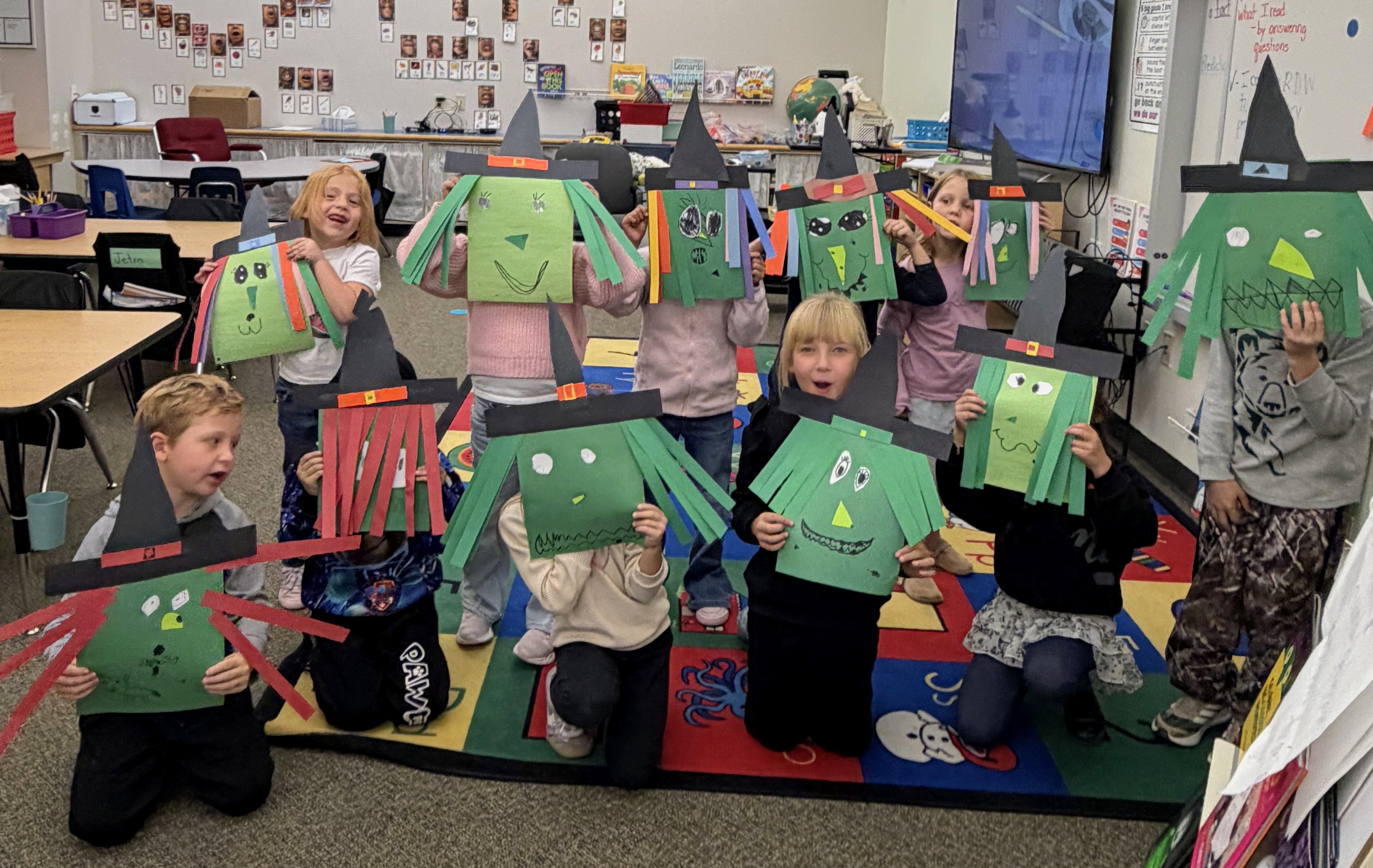 students holding up their witch crafts