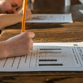 student writing on piece of paper