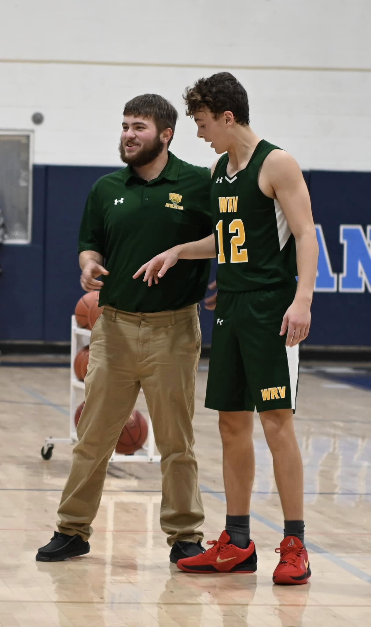 Coach and student on the basketball court