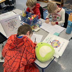 Students writing at a table