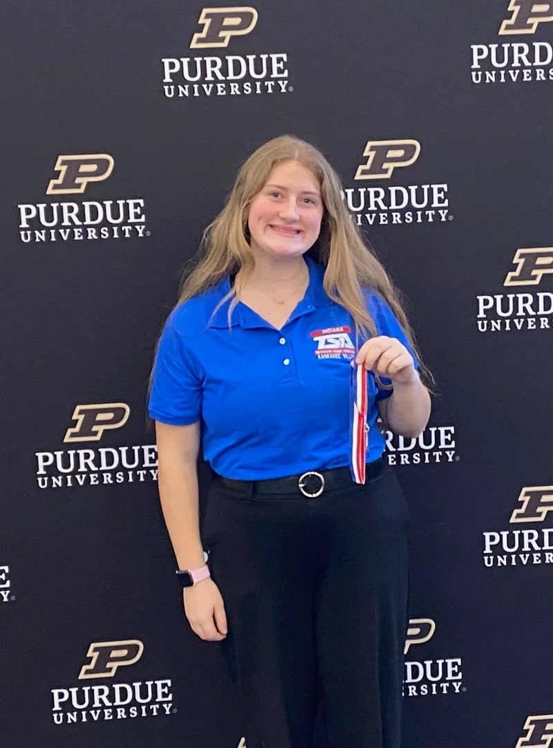 TSA member holding award