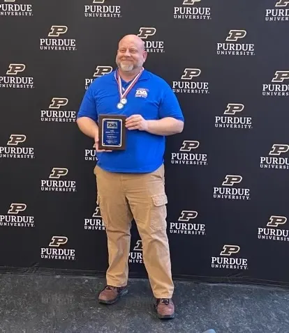 TSA member holding award