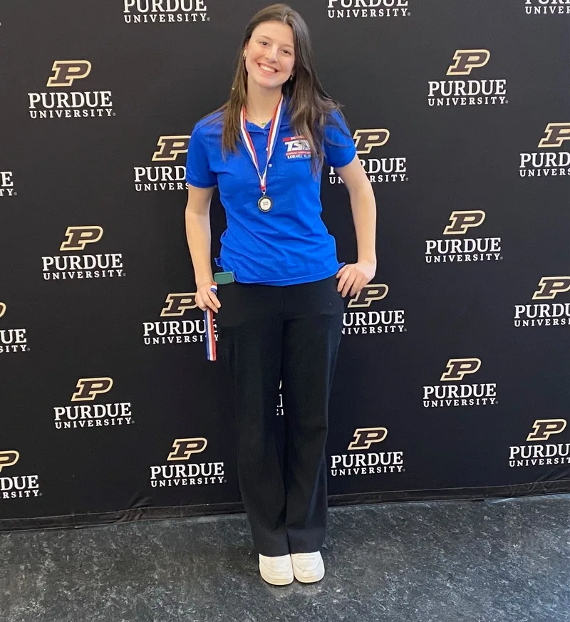 TSA member holding award