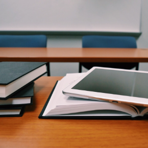 Books and a tablet on a table 