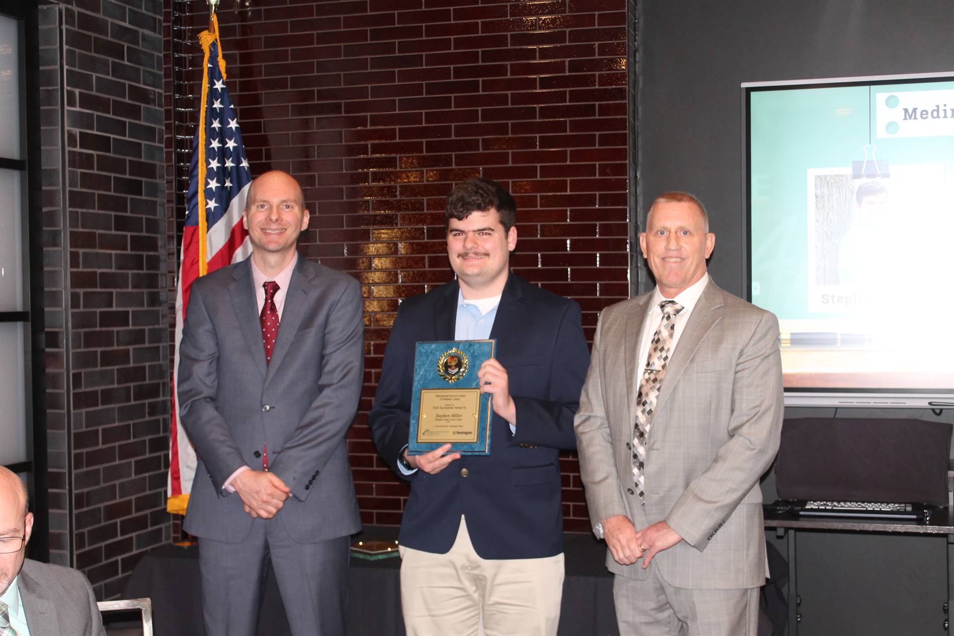 Superintendent Hlasko and Principal Hicks present Stephen Miller with his top scholar award
