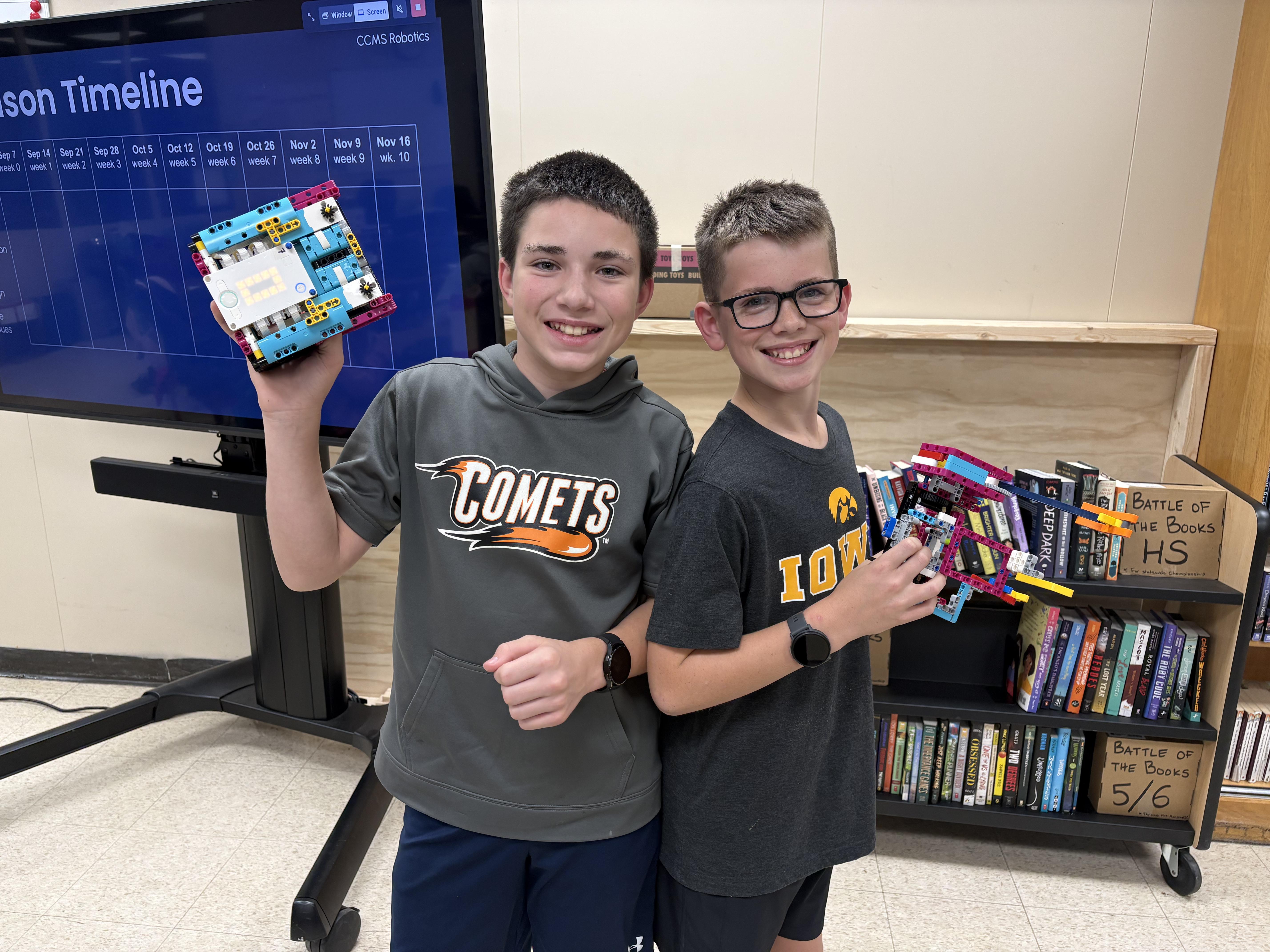 Students Cameron Lessin and Henry Rahmiller show their current robots.