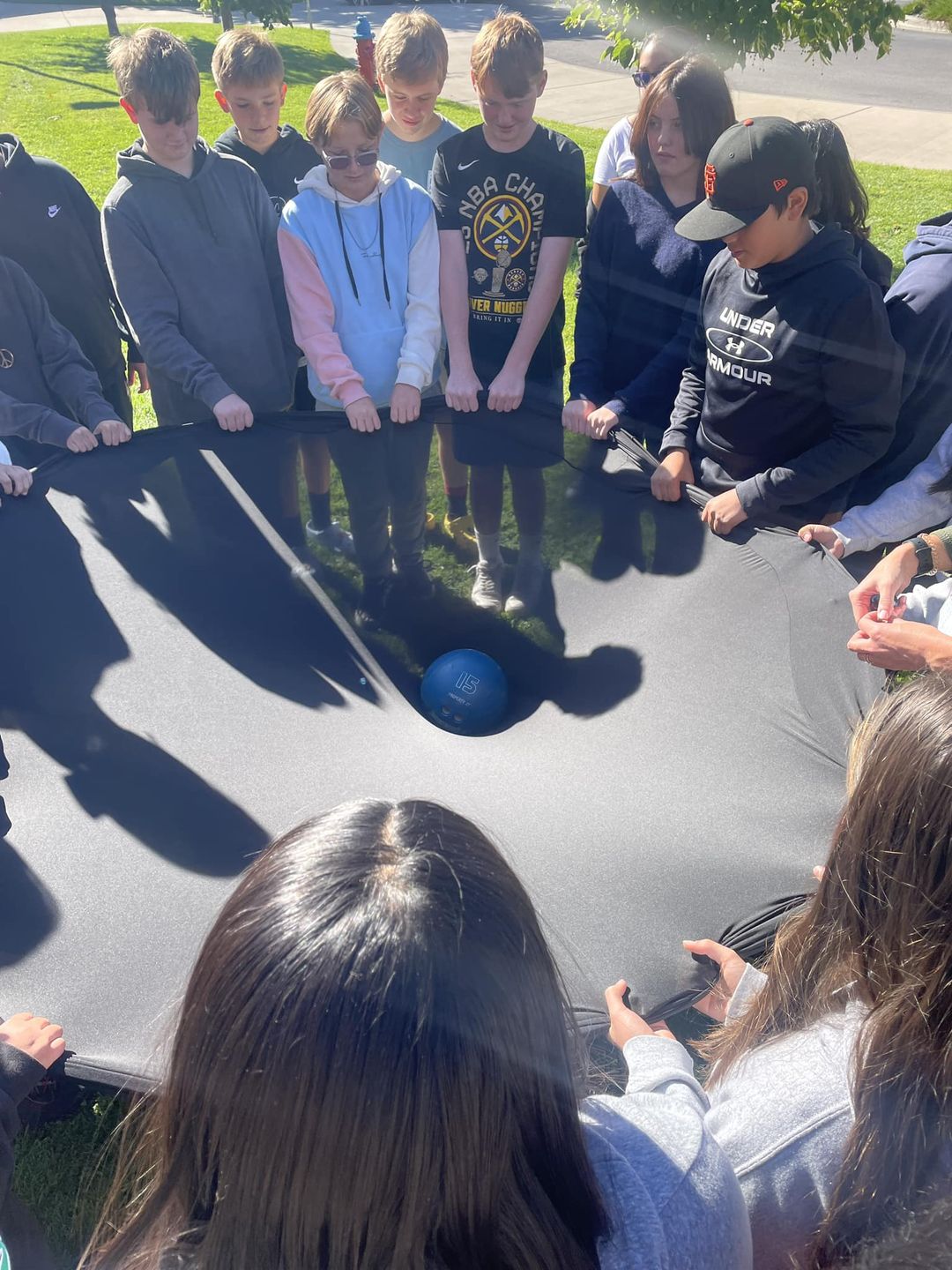8th Graders participating in science experiment outside