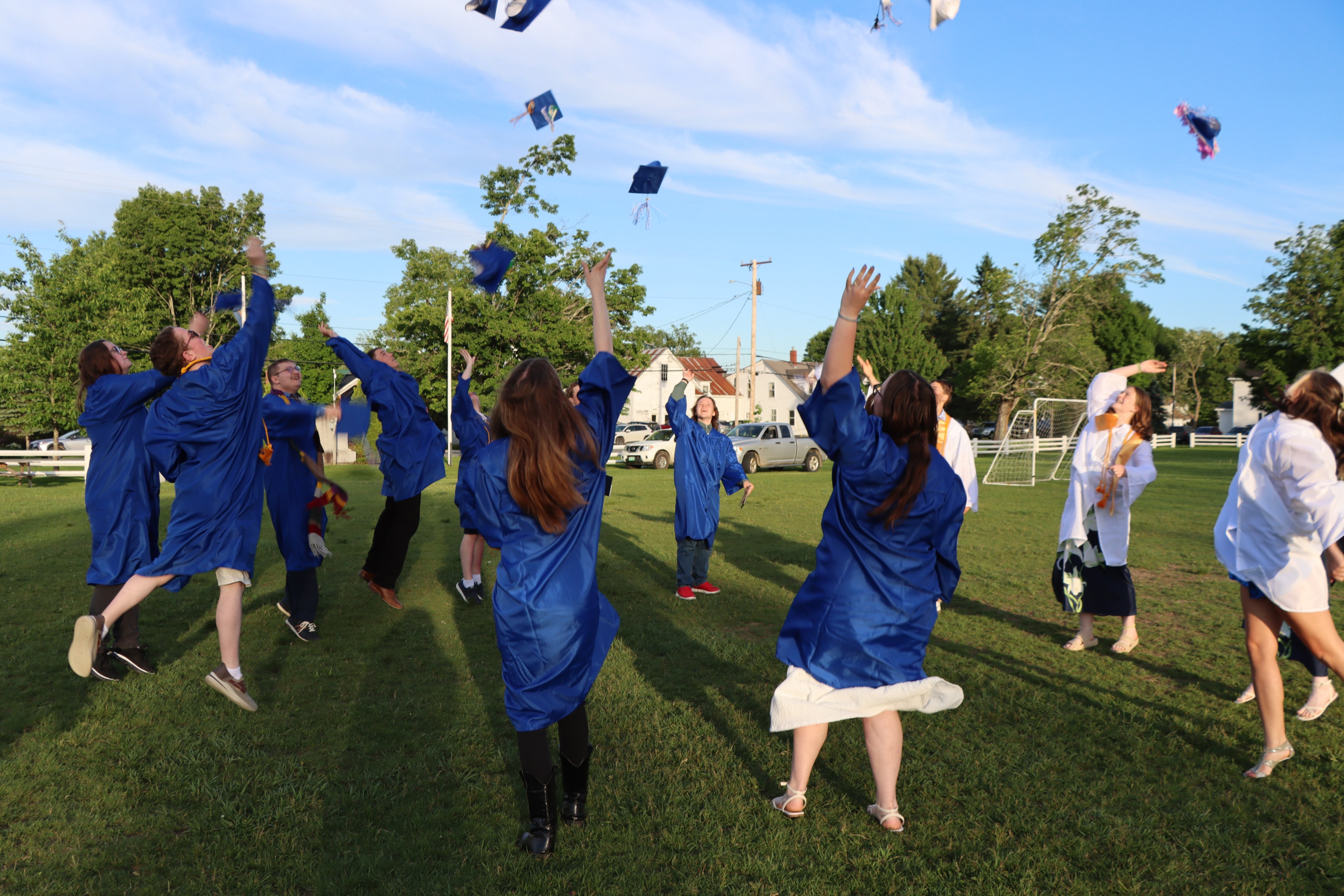 graduation tossing caps into air