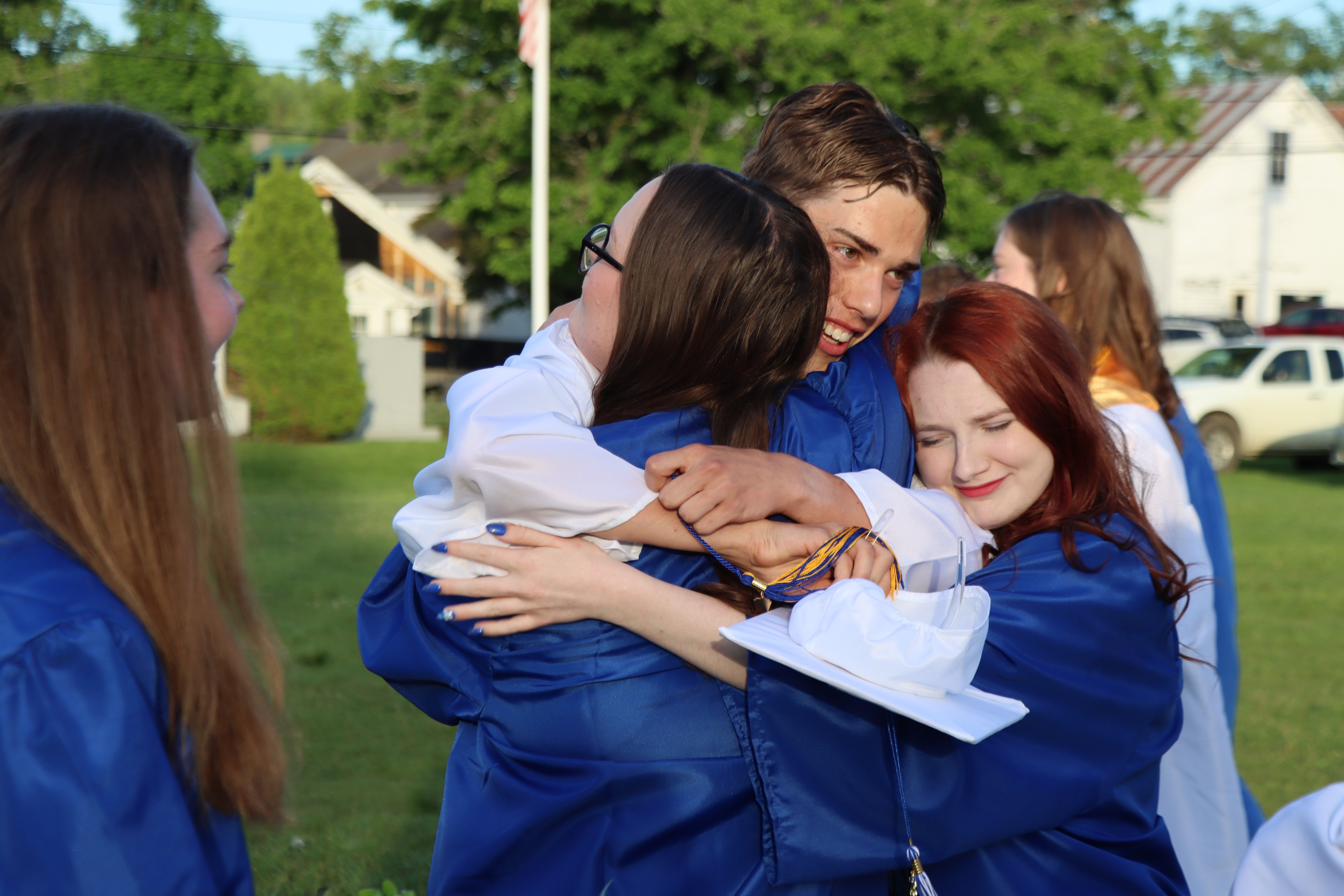 graduates embracing