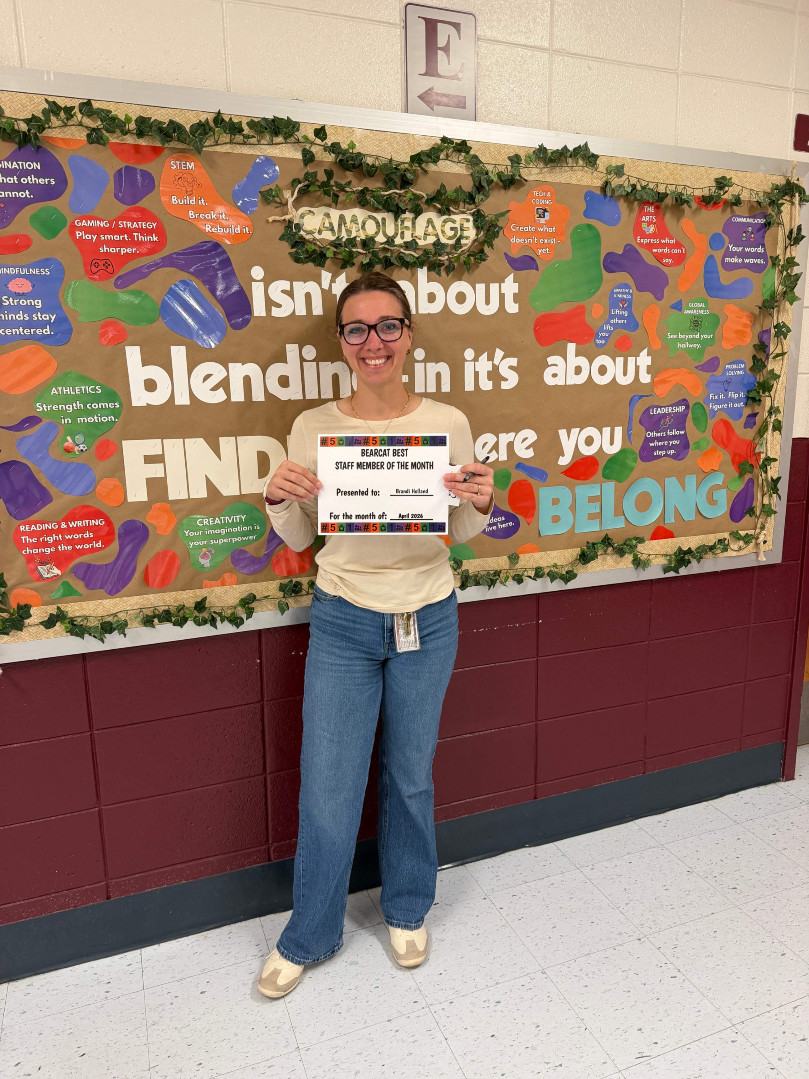 Staff member Brandi Holland holding certificate for being named Staff member of the month 
