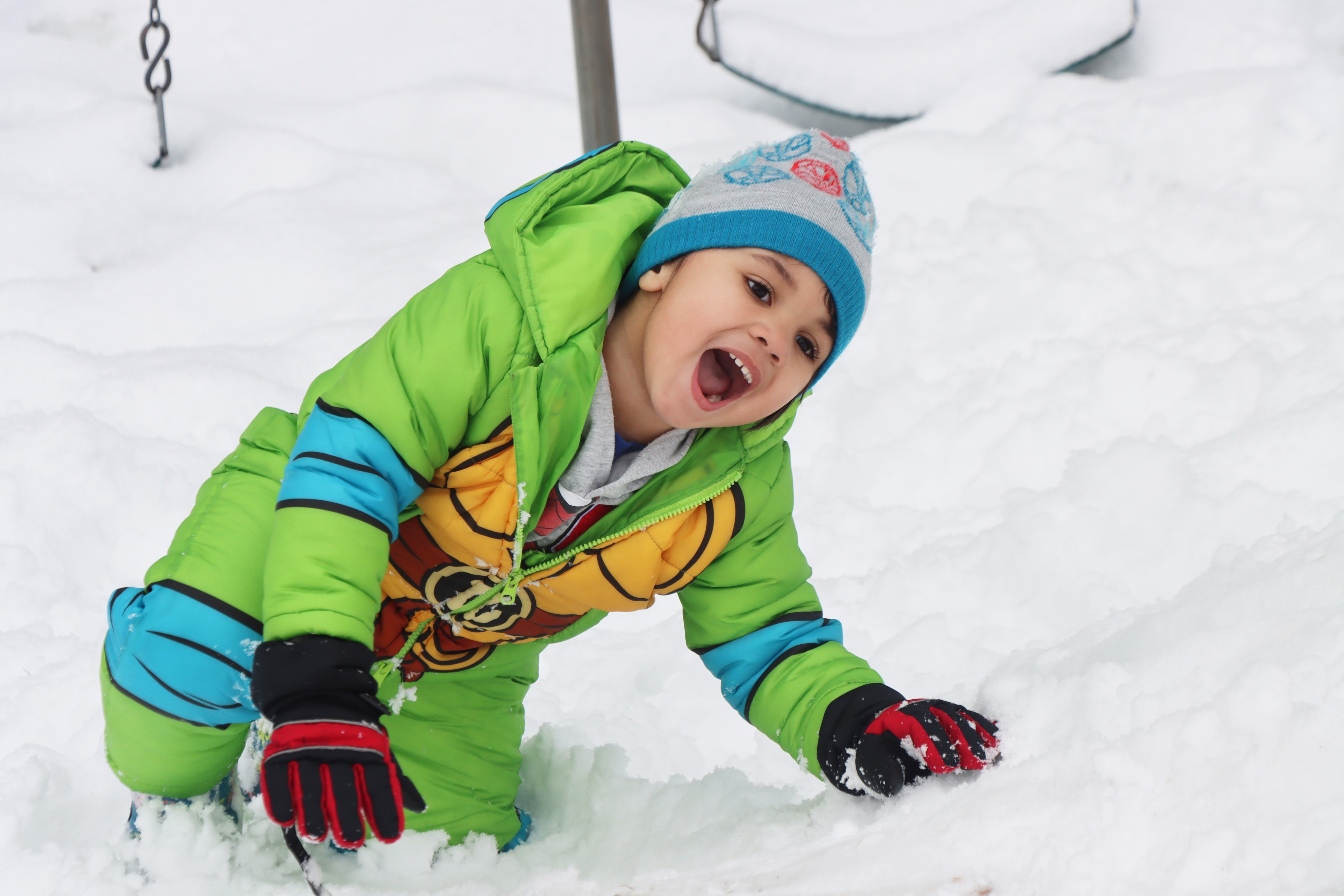 student playing in the snow