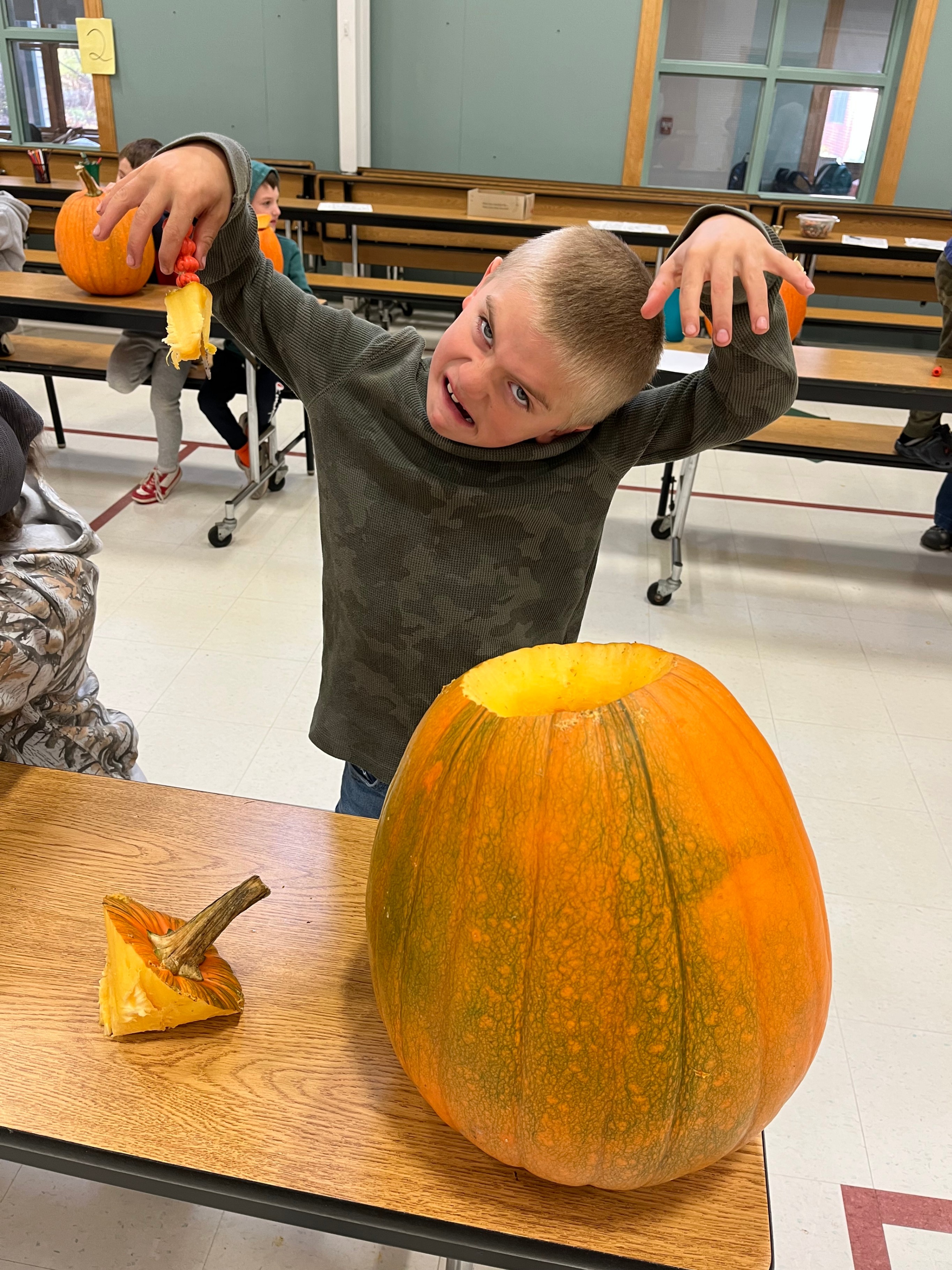 carved pumpkin with student